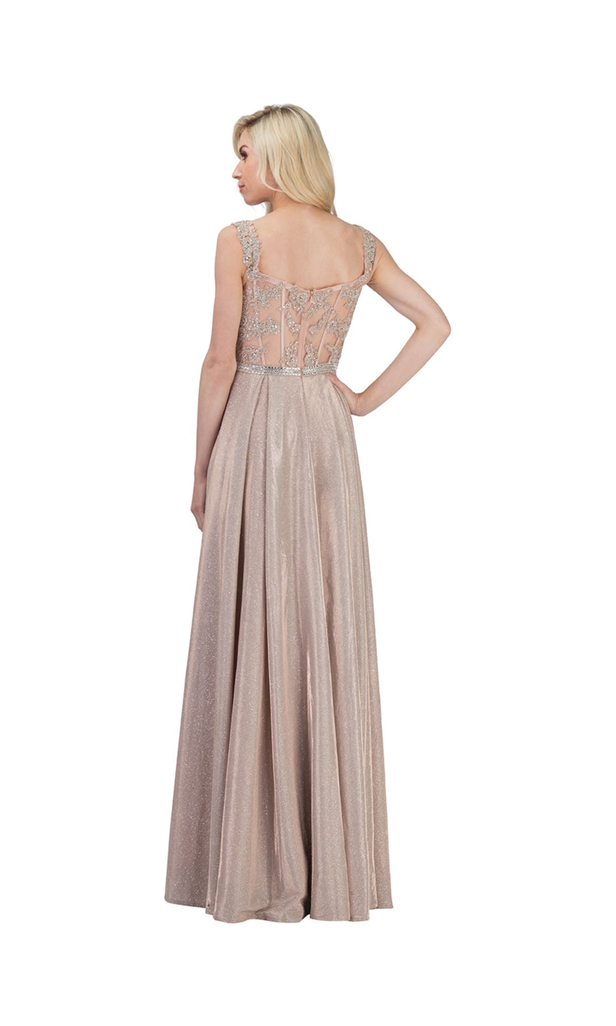 A woman stands facing away in the Chicas DM4008 Beaded-Belt Long Glitter Prom Dress, a floor-length, sleeveless light pink gown with beaded details and a sheer embellished back.